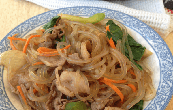 Delicious Beef Japchae small blue and white plate containing delicious beef japchae