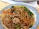 small blue and white plate containing delicious beef japchae