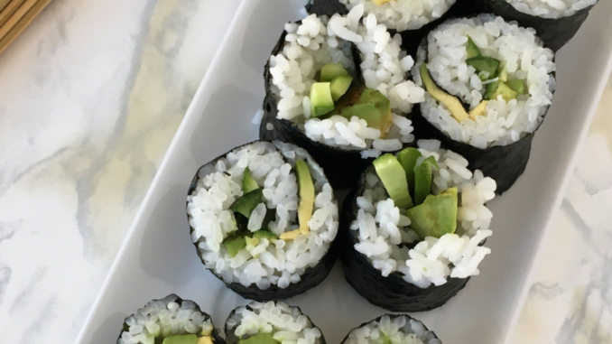 Easy and Allergy Friendly Cucumber and Avocado Sushi Rolls on a white rectangular serving dish