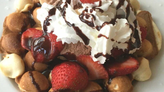 Easy Bubble Egg Waffle Sundae Dessert Bubble Egg Waffle Sundae piled high with ice cream, sliced strawberries, whipped cream, and chococlate sauce drizzle. #nutfree #dessert