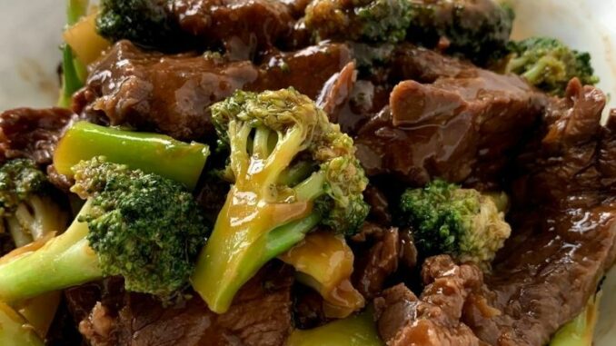 Broccoli-Beef-Stir-Fry Broccoli Beef is ready to eat, photographed in a white serving bowl.